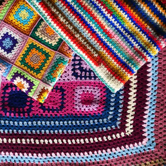 Three crocheted 'granny square' woollen blankets,